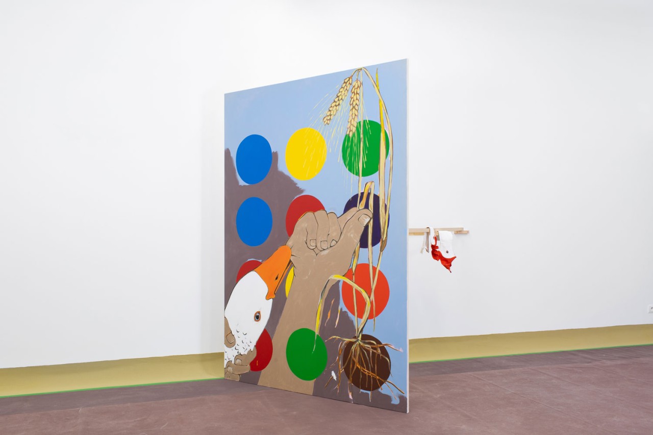 L'oeuvre est une peinture acrylique sur toile de 220 centimètres de haut pour 160 centimètres de large. On y voit une main tenant un épis de blé, une autre tenant la tête d'une oie, des points de couleurs et au fond un rocher gris.
